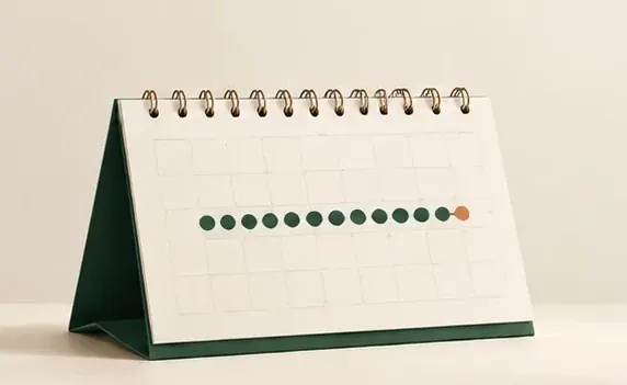 Ilustração de um calendário de mesa com uma sequência de dias marcados